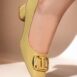 Womens leatherite block heels in light yellow patent with square toe and logo buckle by JULKE
